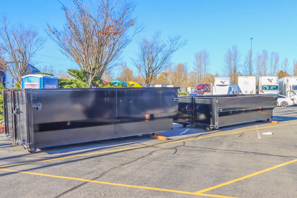 Professional dumpster rental service with roll-off container on residential driveway in Sharon